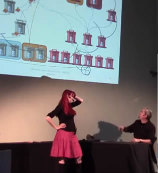 Still of a presentation where a librarian is explaining the library system to a researcher
