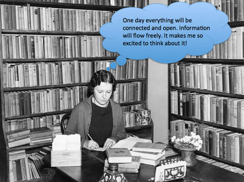 Image of a woman at a desk surrounded by books